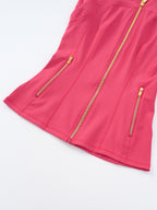 A close-up of a bright pink sleeveless top or dress with gold-tone zippers, including a central front zipper and two side zip pockets, shown on a clean white background.