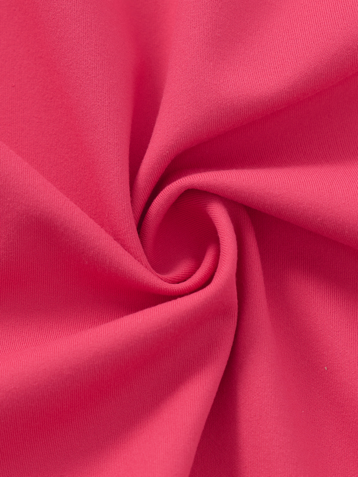 A close-up of bright pink fabric arranged in a spiral drape, showing the material texture and color.